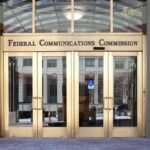 glass and metal doorways with the words Federal Communications Commission