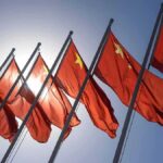 Red flags with yellow stars on flagpoles.