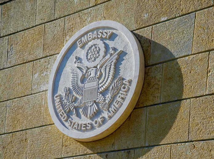 1092812744 featured image symbol of a US Embassy hanging on a wall