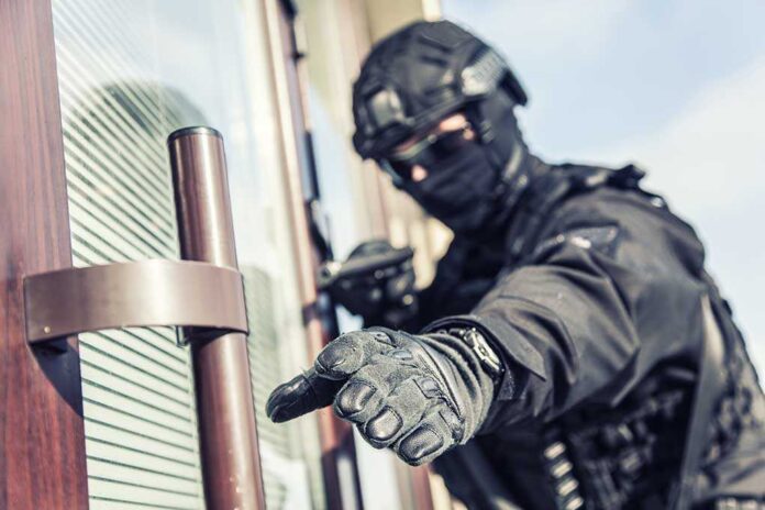 1391041319 featured image SWAT officer reaching for door handle.