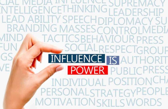 198856733 featured image Hand holding block text influence is power