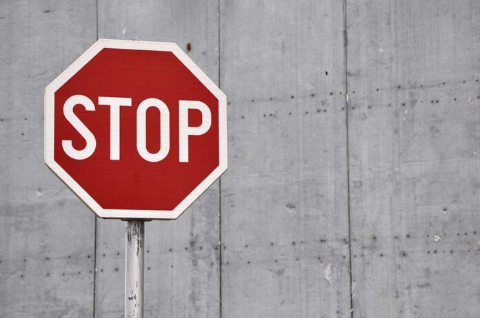 567891499 featured image Red stop sign against concrete wall background