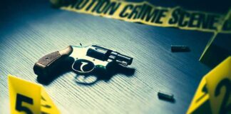 Revolver on table with crime scene markers