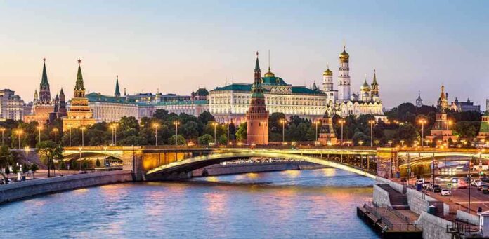 1419194690 featured image Illuminated bridge and Kremlin complex across river at twilight.