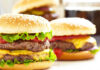 Cheeseburgers with lettuce tomato and sesame seed buns