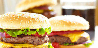 Cheeseburgers with lettuce tomato and sesame seed buns
