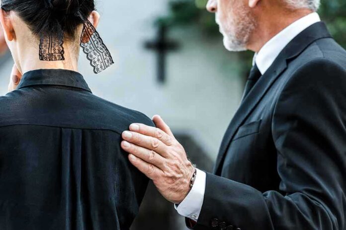 1500621305 featured image Man comforting woman at funeral service.