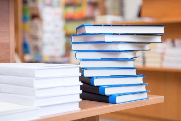 182569214 featured image two piles of books in foreground, with stacks of books out of focus in the background.