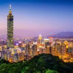 Taipei skyline at dusk with Taipei 101 tower.