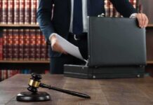 Gavel and person opening briefcase in law office
