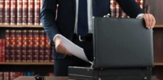 Gavel and person opening briefcase in law office