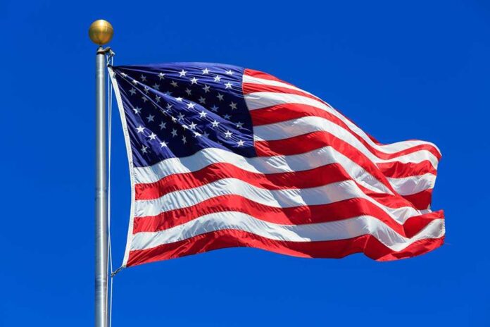 American flag waving against a clear blue sky