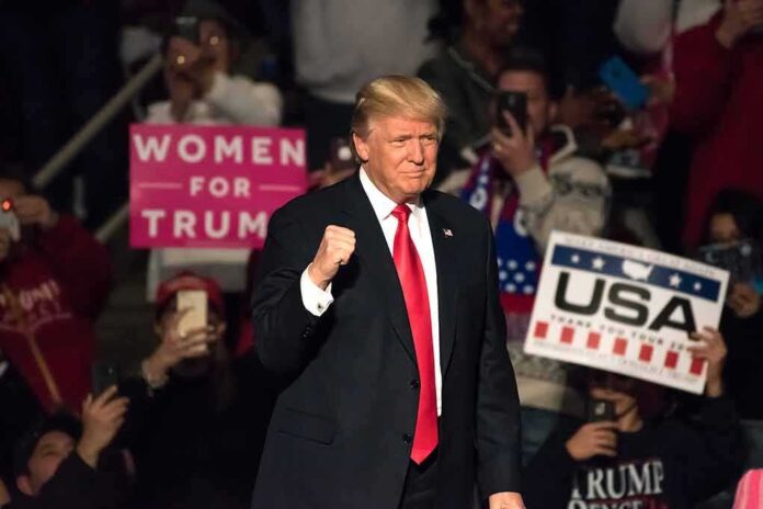 560025514 featured image Man in suit at rally crowd holding signs