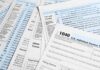 Tax forms and documents overlapping on surface