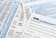 Tax forms and documents overlapping on surface