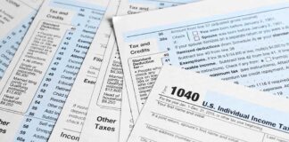 Tax forms and documents overlapping on surface