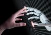 Human and robotic hand reaching out to touch.