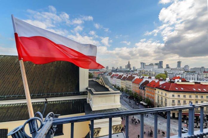 704626399 featured image Polish flag over cityscape with buildings and cloudy sky.