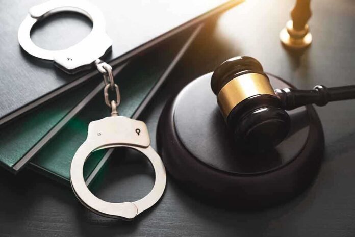 Gavel handcuffs and books on a table
