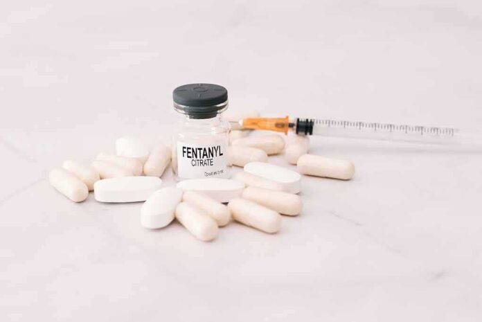 Vial labeled fentanyl surrounded by pills and syringe