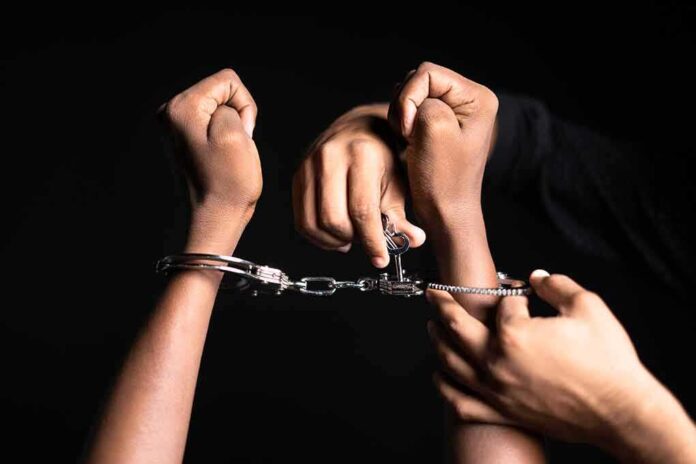 2160794121 featured image Handling handcuffs and unlocking with a key.