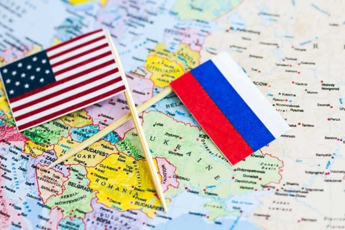 U.S. and Russian flags on a world map