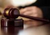 Gavel resting on a wooden sound block