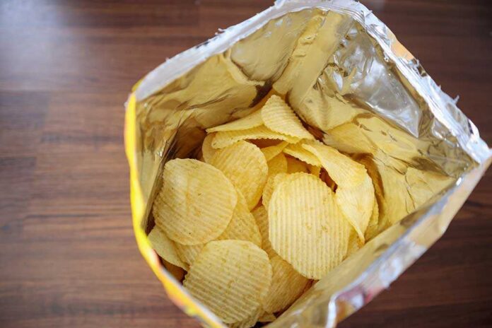1142853884 featured image Open bag of ridged potato chips