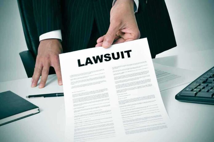 189871757 featured image Person holding a document labeled Lawsuit