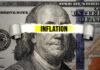 Inflation text over torn hundred dollar bill