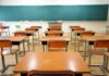 Empty classroom with desks and a chalkboard