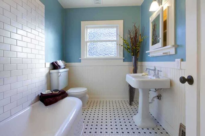 Modern bathroom with blue walls and white fixtures