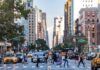 Busy city street with pedestrians and cars.