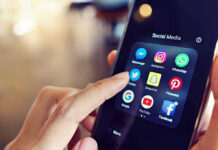 Finger tapping smartphone social media app icons