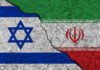 Israeli and Iranian flags divided by a cracked line