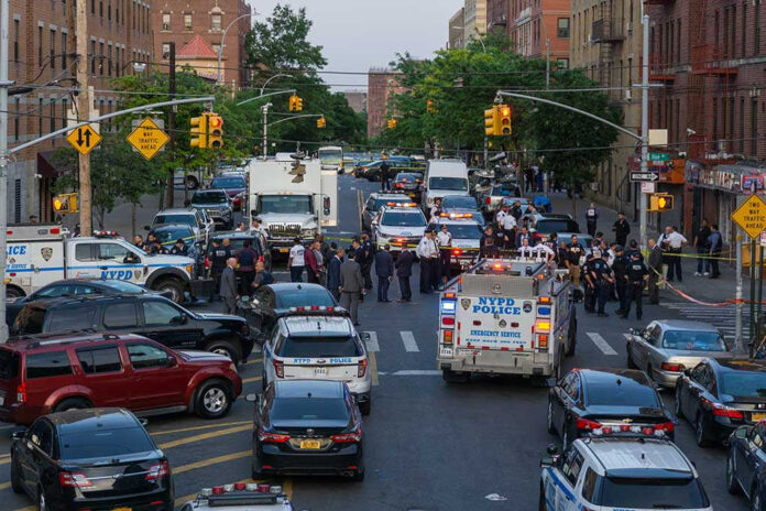1976471648 Police activity on a city street with emergency vehicles