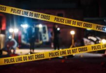 Yellow police tape in front of crime scene