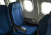 Empty airplane seats next to windows