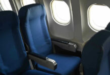Empty airplane seats next to windows