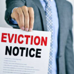 Man holding eviction notice in hand