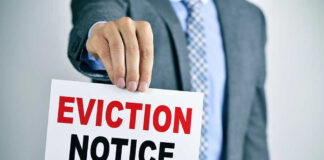Man holding eviction notice in hand