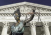 Lady Justice statue in front of courthouse