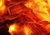 Burning US dollar bills surrounded by flames