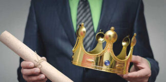 Person holding a crown and a scroll
