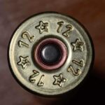 Close-up view of the base of a 12 gauge shotgun shell