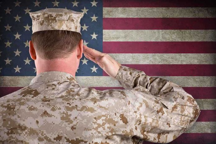 A soldier in uniform saluting in front of the American flag