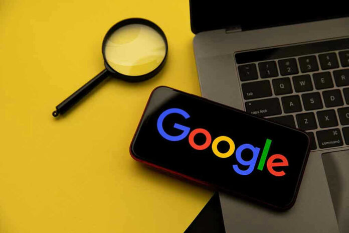 Magnifying glass, laptop, and smartphone displaying Googles logo.