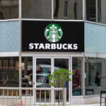 Global Boycott Crushes Starbucks—900 Jobs Gone Starbucks storefront with glass doors and logo