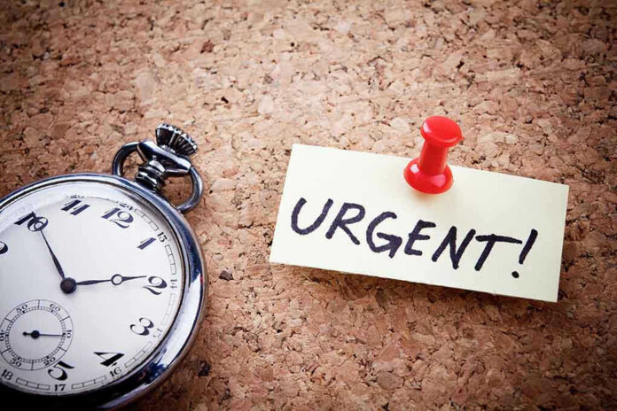 Pocket watch and urgent note pinned on corkboard