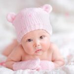 UNBELIEVABLE Parking Lot Birth – Fast Food Surprise! A cute baby wearing a pink knitted hat and mittens, lying on a soft surface